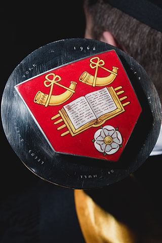 University coat of arms on metal disk