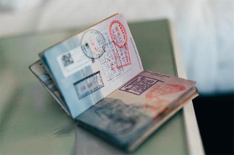 An open passport showing travel stamps