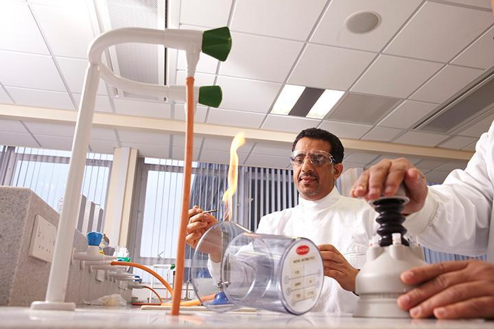 A landscape image of a technician carrying out an experiment.