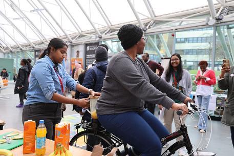 Students making banana smoothies on static bike on sustainability day