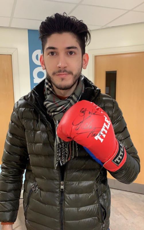Osman Ehtsham, 2020 BSc Accounting, Finance and Economics alumnus, with a signed boxing glove