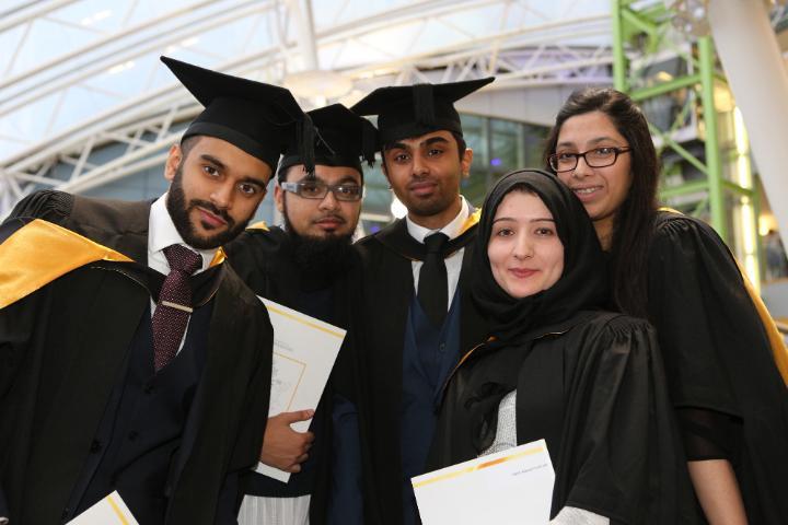 A group of five students posing on their graduation ceremony 