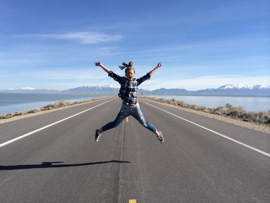 A jumping student on a desert highway