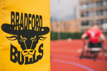Bradford Bills logo with a rugby wheelchair player in the background