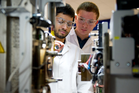 Two civil engineering students in googles and lab coats
