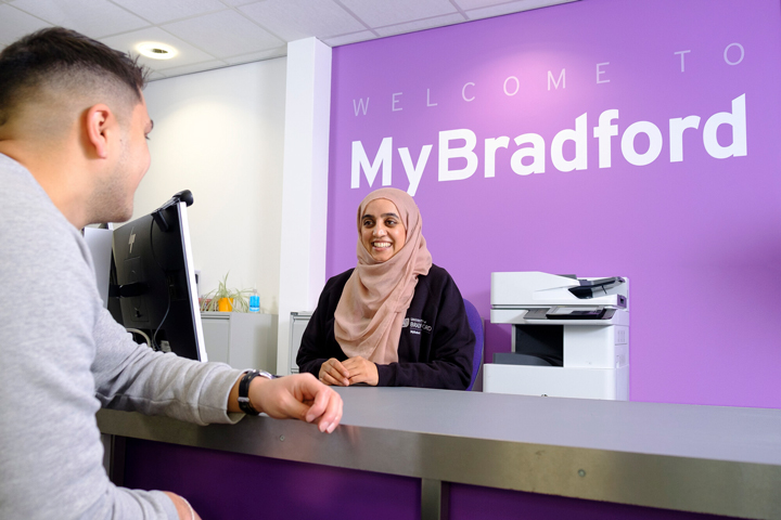 A member of the MyBradford support team talking to a student.