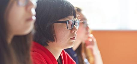 Student with glasses in language class.