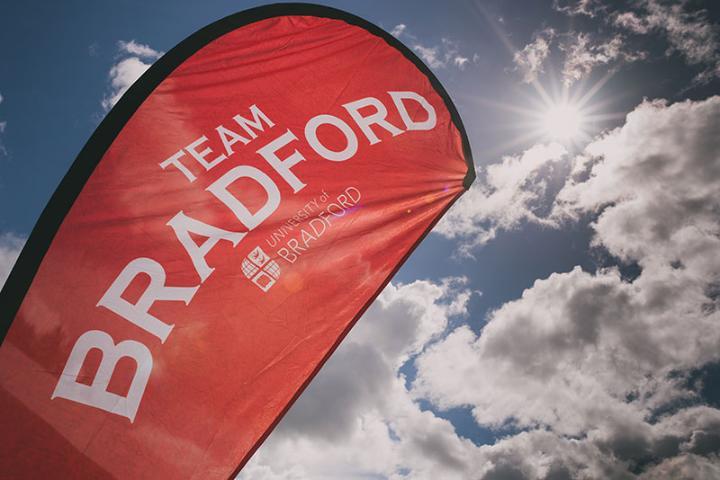 An image of a Team Bradford flag with the sky in the background.