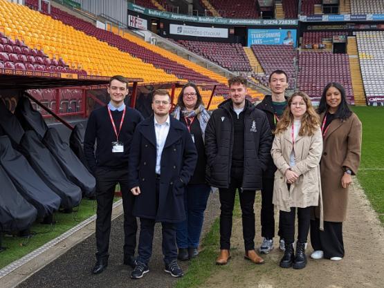 Seven people stood pitchside in a football stadium