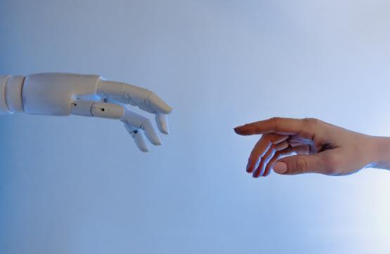 Robot hand reaching out to human hand