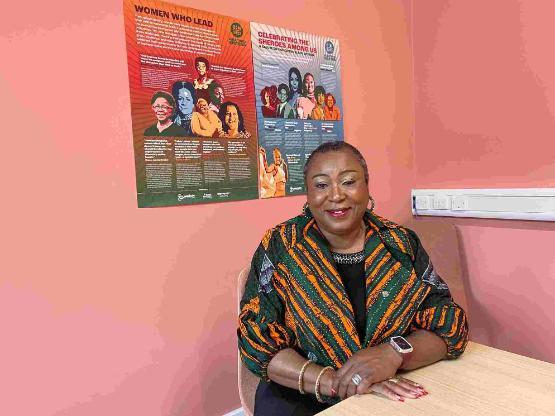 Lecturer sat down in front of Black History Month posters