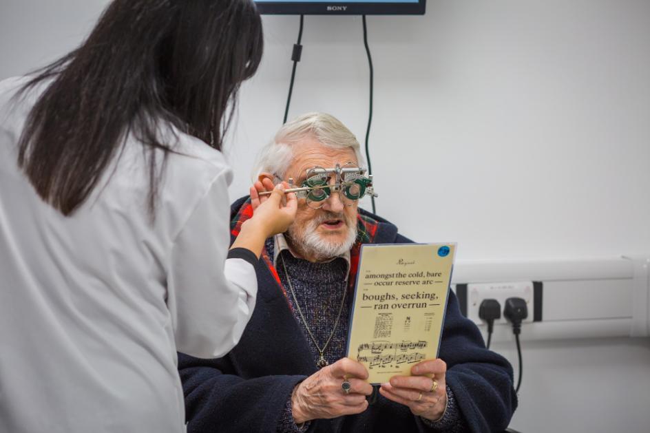 Elderly man having glasses fitted