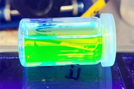 semiconductor nanoparticles in a test tube emitting green light