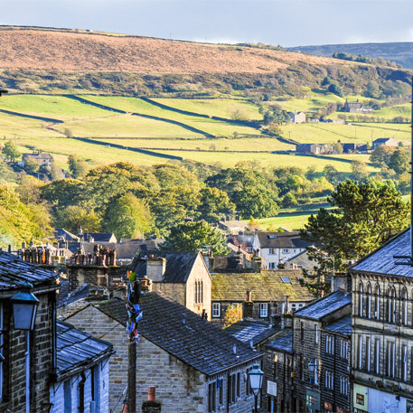 A view of the countryside with Haworth main street buildings in the foreground