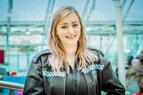 Keeley Hirst smiling at the camera and wearing police csi uniform