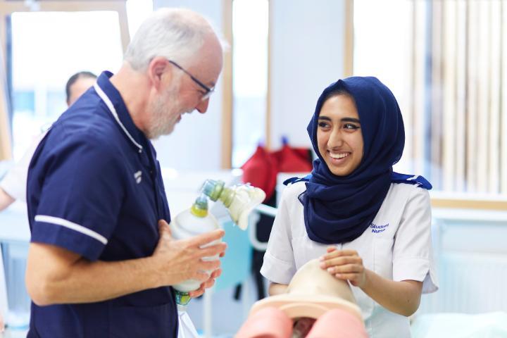 A student nurse and an academic in a nursing practical session
