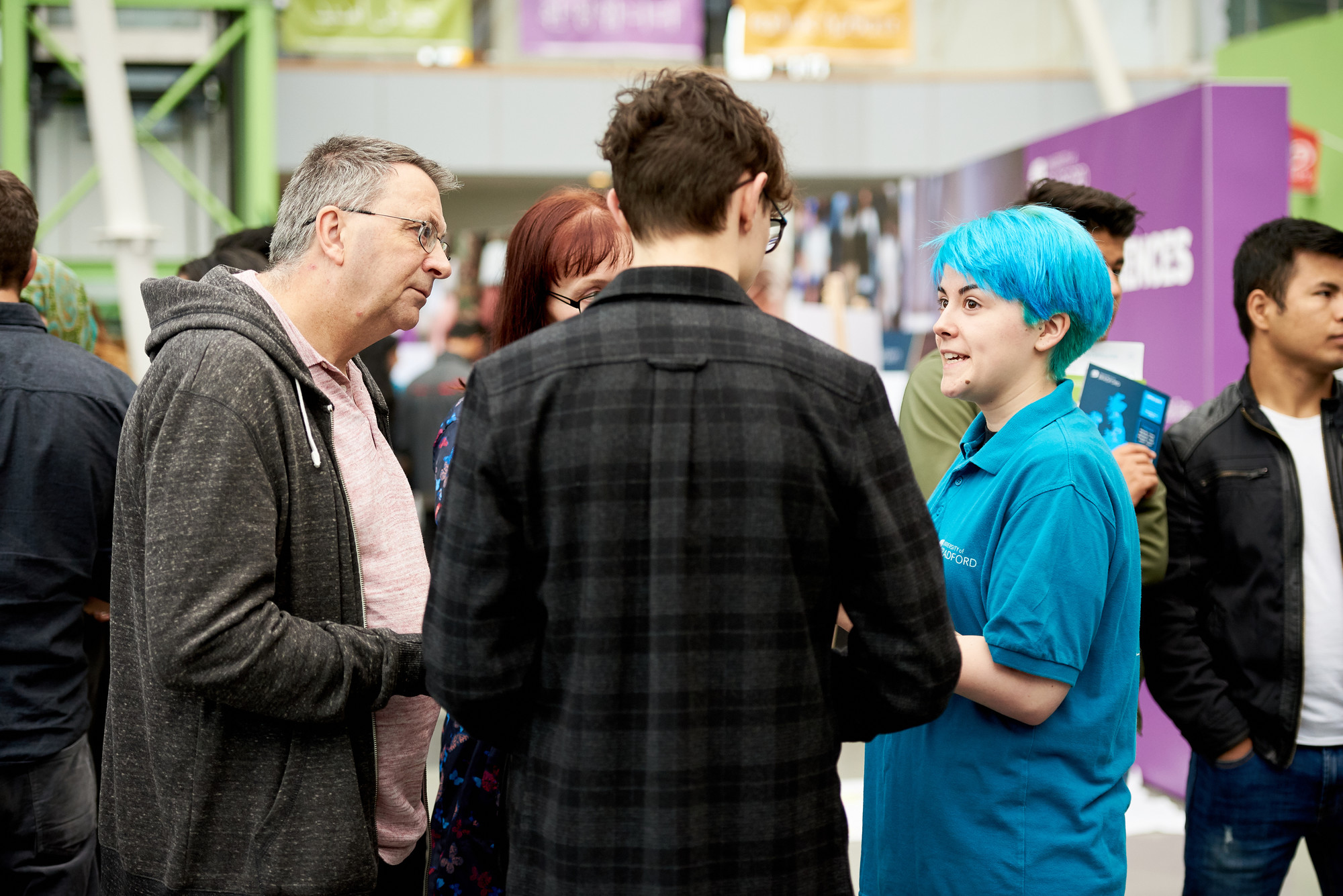 A University of Bradford student talking to visitors at an Open Day
