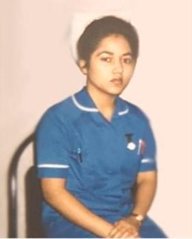 Rukeya Miah wearing a blue nursing uniform, in her early career as a nurse. A young woman in a nurses uniform