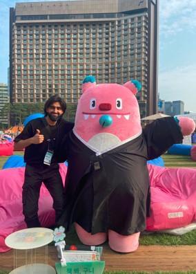 Amaan Munir pictured with a giant pink children's cartoon character Amaan Munir pictured with a giant pink children's cartoon character