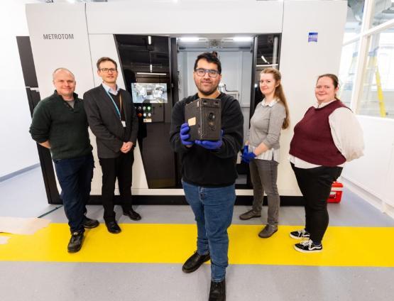 Academics holding original Cottingley Fairy camera in front of a CT scanner Academics holding original Cottingley Fairy camera in front of a CT scanner