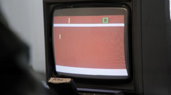 A 1980s video game is played on a TV screen A 1980s video game is played on a TV screen
