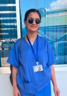 Turing Scheme student Alia Hussain wearing medical gowns Turing Scheme student Alia Hussain wearing medical gowns
