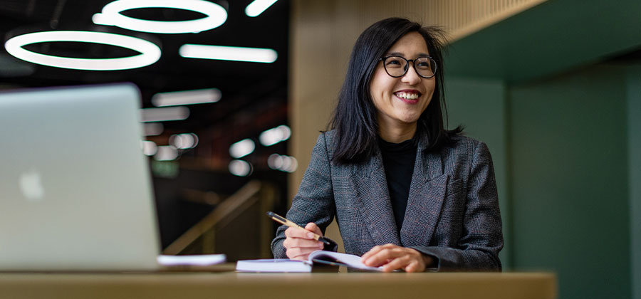A student smiling and looking away from the camera.