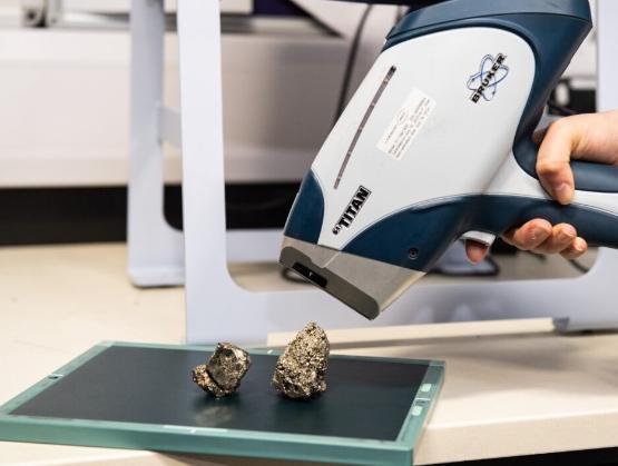 An x-ray gun being pointed at a sample of fools gold An x-ray gun being pointed at a sample of fools gold