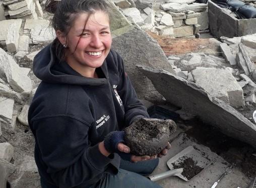 Archaeologist holding Iron Age cup Archaeologist holding Iron Age cup