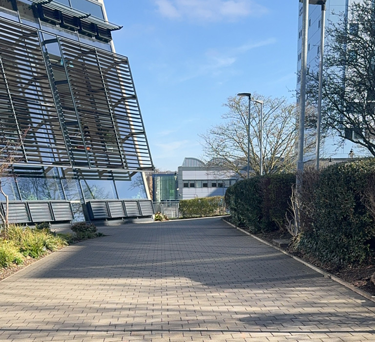 Immar walking past the School of Management building.