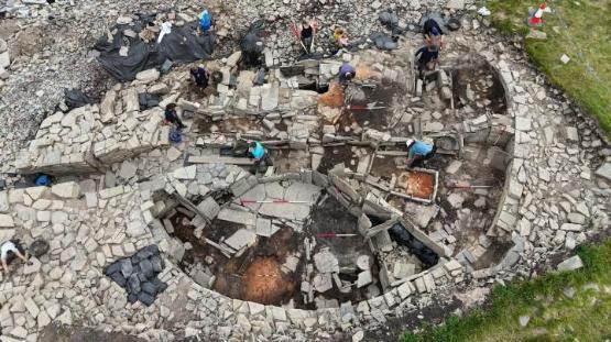 A group of people taking part in an archaeological dig A group of people taking part in an archaeological dig