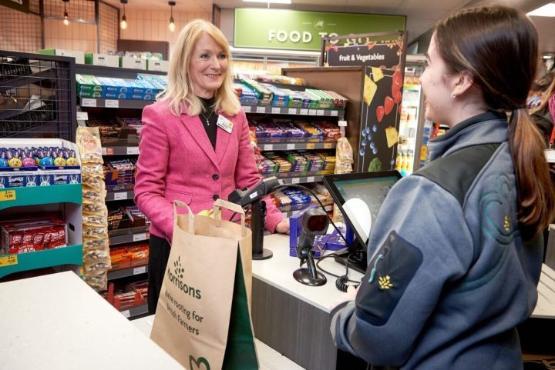 person at till of shop person at till of shop