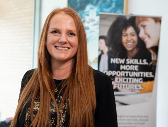 A head and shoulders picture of a person at a university event A head and shoulders picture of a person at a university event