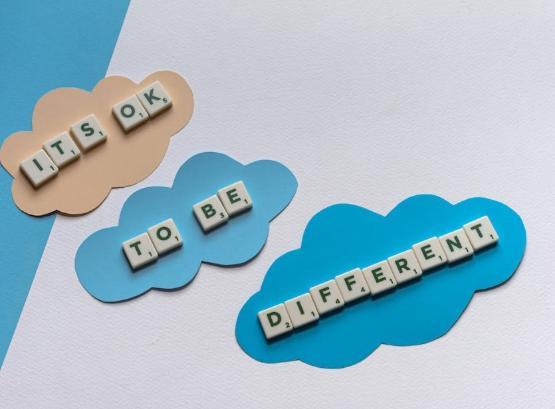 Letters on coloured card spelling out It's ok to be different Letters on coloured card spelling out It's ok to be different