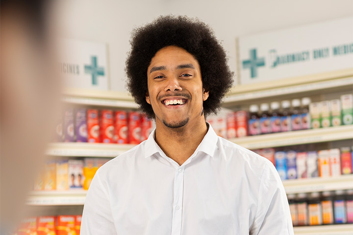 A pharmacy student in the mock pharmacy. A pharmacy student in the mock pharmacy.
