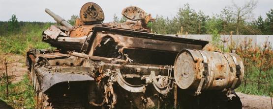 a tank in the field pointing its gun