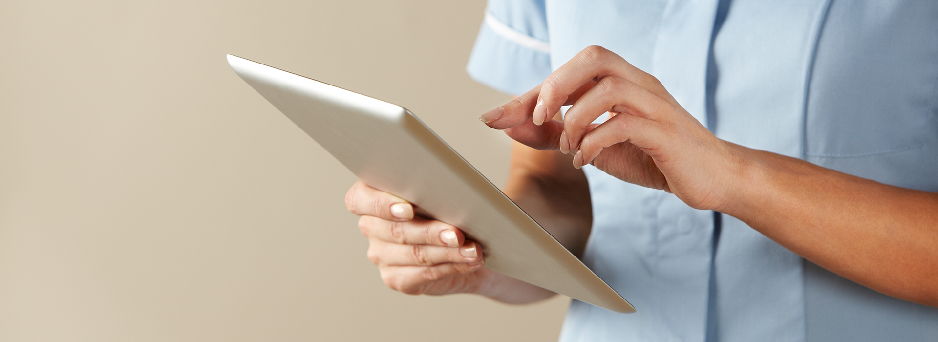 Close up of a nurse holding a digital tablet