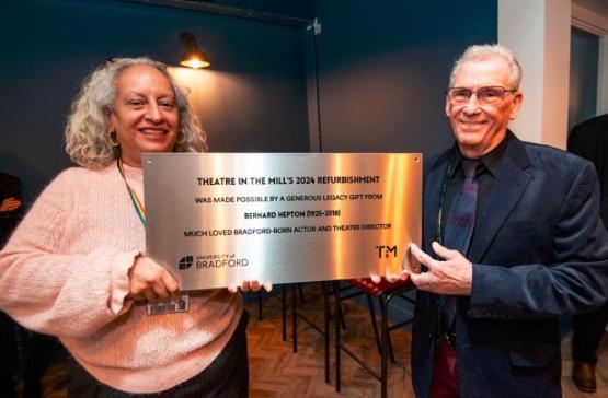 Shabina Aslam and Lawrence Gill holding a commemorative plaque Shabina Aslam and Lawrence Gill holding a commemorative plaque