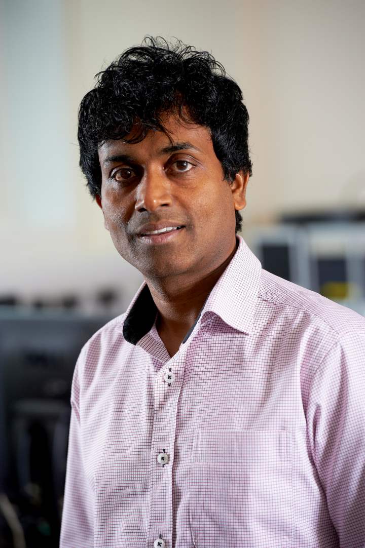 A head and shoulders photo of a person dressed in an open necked shirt A head and shoulders photo of a person dressed in an open necked shirt
