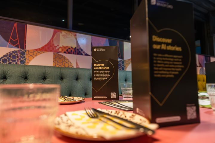 A close up photo of an empty restaurant table featuring an empty plate with cutlery and a couple of menus A close up photo of an empty restaurant table featuring an empty plate with cutlery and a couple of menus