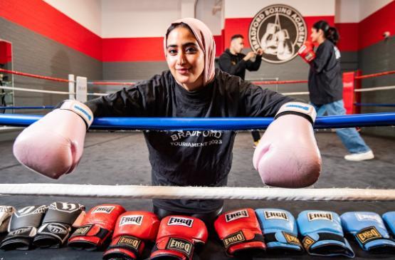 Dr Alaa Alshaabi wearing boxing gloves in the ring Dr Alaa Alshaabi wearing boxing gloves in the ring