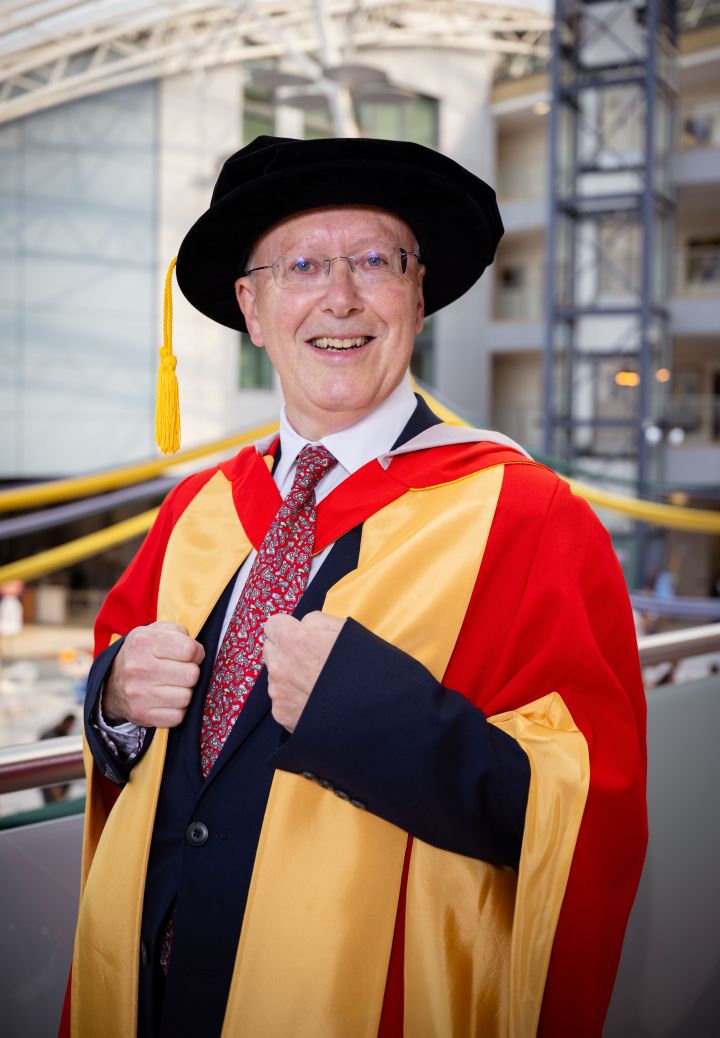 person in graduation gown and cap holds their hands in front of them person in graduation gown and cap holds their hands in front of them