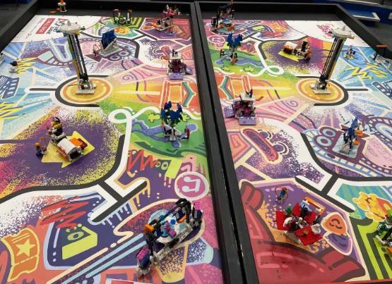A picture looking down at a multicoloured table with Lego models on it A picture looking down at a multicoloured table with Lego models on it