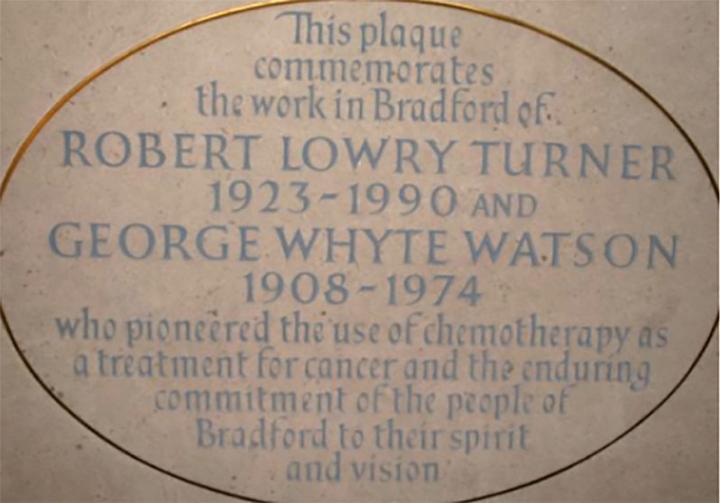 Close up of plaque at Bradford Cathedral commemorating the cancer research of Robert Turner and George Watson