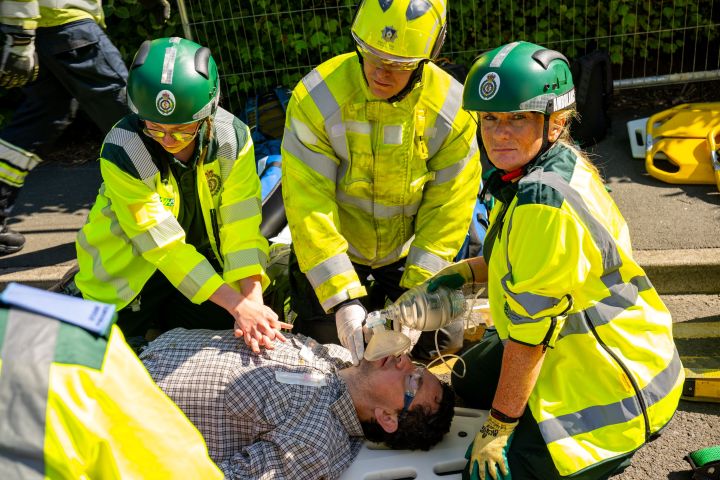 Three paramedics give cpr to a patient