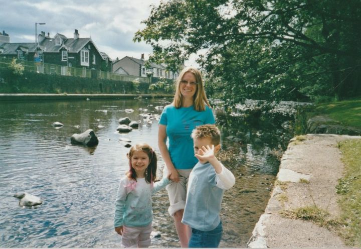 A mother with her two children in a river A mother with her two children in a river