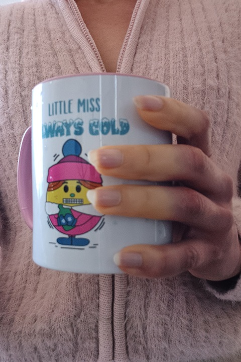 Close up on a hand showing effects of Raynauds holding a mug Close up on a hand showing effects of Raynauds holding a mug