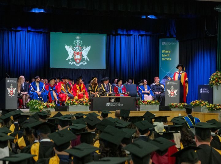 a scene of a full graduation ceremony showing a number of students in the audience dressed in graduation hats a scene of a full graduation ceremony showing a number of students in the audience dressed in graduation hats