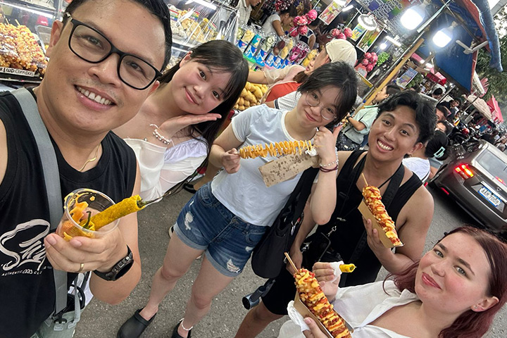 Courtney, on the far right, eating a corndog with friends. Courtney, on the far right, eating a corndog with friends.
