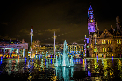 Fountain spouting water at Bradford Centenary Square at night